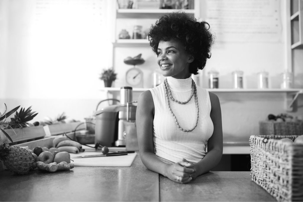 Young lady smiling while sitting at counter top